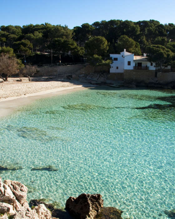 Panoramic view of Cala Gat and its crystal clear waters.